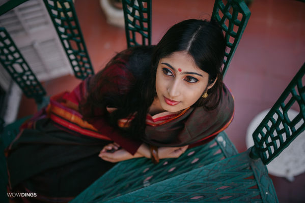 Bengali girl in a traditional saree on the stairs