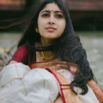 bengali girl in a traditional dress sitting on a boat