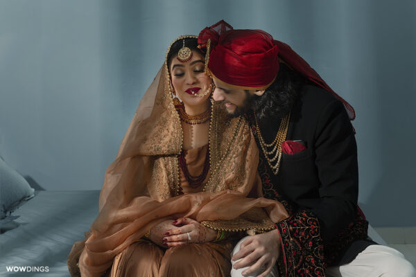 Beautiful traditional Muslim bride and groom chatting in a delhi wedding
