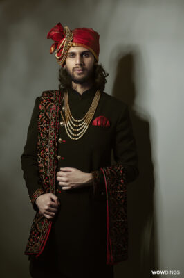 Traditional Muslim groom wearing sherwani formal wedding studio portrait in delhi