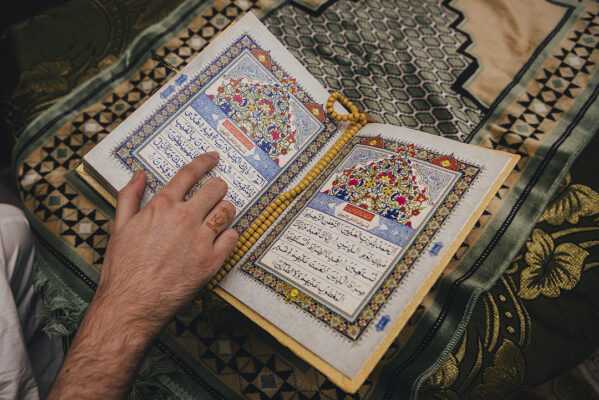Reading Quran shariff in the morning of Wedding by a muslim groom on his wedding with mehndi on hand ja e namaz rehl tasbih in delhi