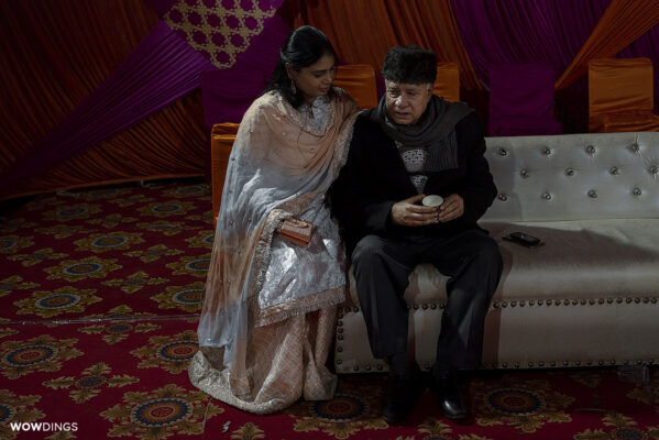 Bride's father being comforted by family during brides vidaai rukhsati at a muslim wedding in delhi
