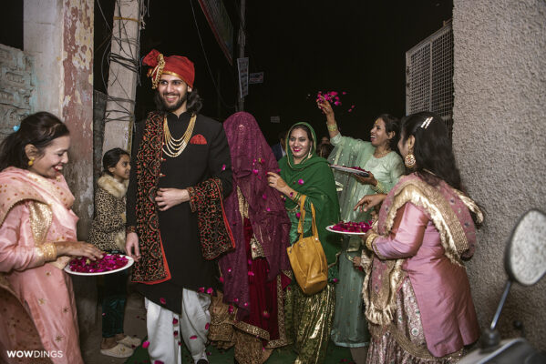 welcoming the bride at groom's house with rose petals in a muslim wedding in delhi
