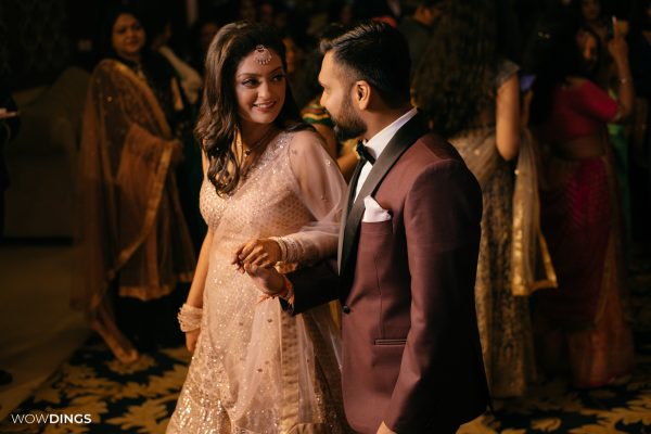 casual couple portrait as they enter the engagement ceremony at an indian wedding candid photography in delhi