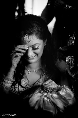 beautiful bridal moment portrait godh bharai ritual showering bride with gifts at an indian wedding in delhi on engagement day candid photography