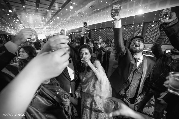people raising a toast to bride and groom wishing them happiness at a delhi wedding candid photography