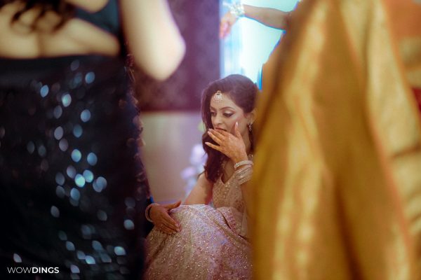 casual bridal portrait moment during godh bharai ritual showering bride with gifts at an indian wedding in delhi on engagement day candid photography