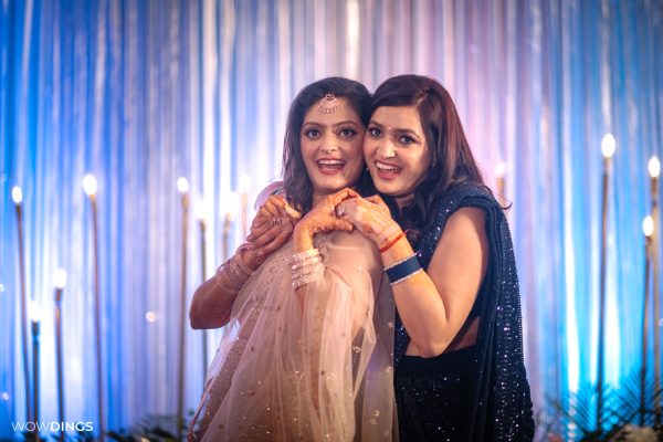 bride posing with sister Superman got hitched candid wedding photography in delhi