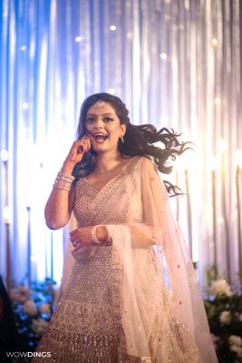 beautiful bride dancing on sangeet ceremony at an indian wedding in delhi on engagement day candid photography