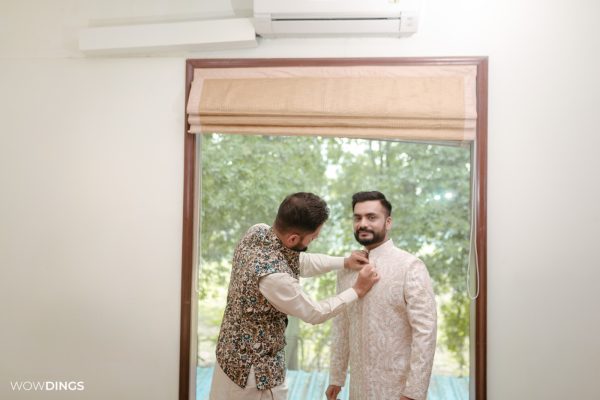 groom getting ready for wedding candid photography