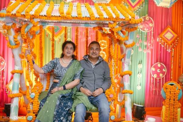 colourful wedding decor on a swing with marigold garlands in delhi candid photography