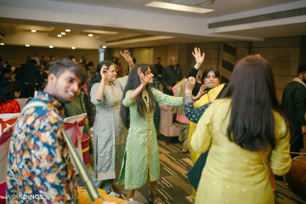 Mehndi and sangeet Ceremony of Delhi weddings candid photography of people dancing