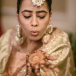 Muslim bride's hands with intricate mehndi designs during a vibrant ceremony