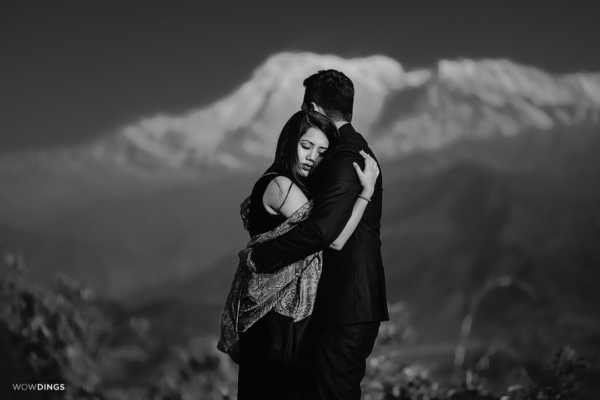 couple hugging in front of fishtail mountain pokhora