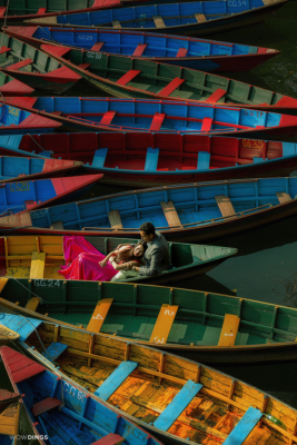 couple on the colorful boats in phewa lake nepal