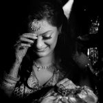 beautiful bridal moment portrait godh bharai ritual showering bride with gifts at an indian wedding in delhi on engagement day candid photography
