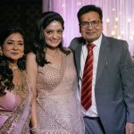 bride with family portrait on engagement day of an indian wedding in delhi on engagement day candid photography