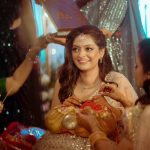casual bridal moment godh bharai ritual showering bride with gifts at an indian wedding in delhi on engagement day candid photography
