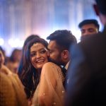 couple kissing casual moment at a delhi wedding sangeet ceremony candid photography