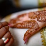 Mehndi Ceremony of Delhi bride candid wedding photography close-up of hand