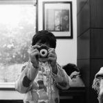 kid taking photo with polaroid camera at a delhi wedding candid photography