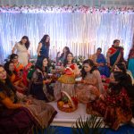 godh bharai ritual showering bride with gifts at an indian wedding in delhi on engagement day candid photography