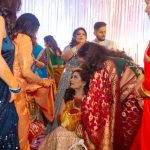 godh bharai ritual showering bride with gifts at an indian wedding in delhi on engagement day candid photography