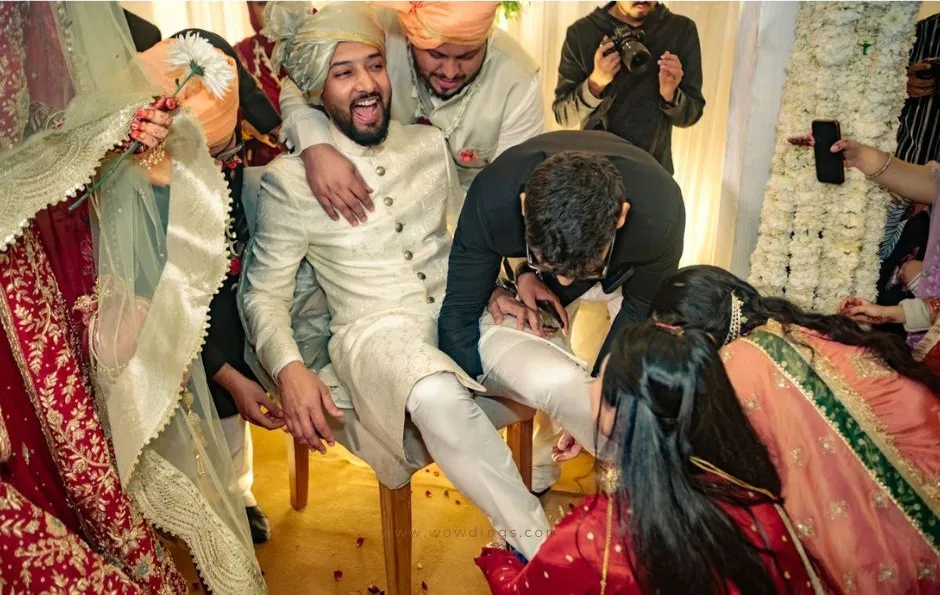 Nikaah: a muslim wedding photography blog 26 Joota chhupai rasam or hiding the shoe fun ritual in indian weddings